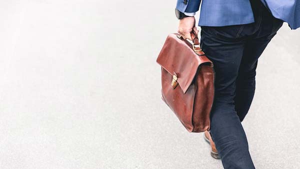 Man walking with brown briefcase